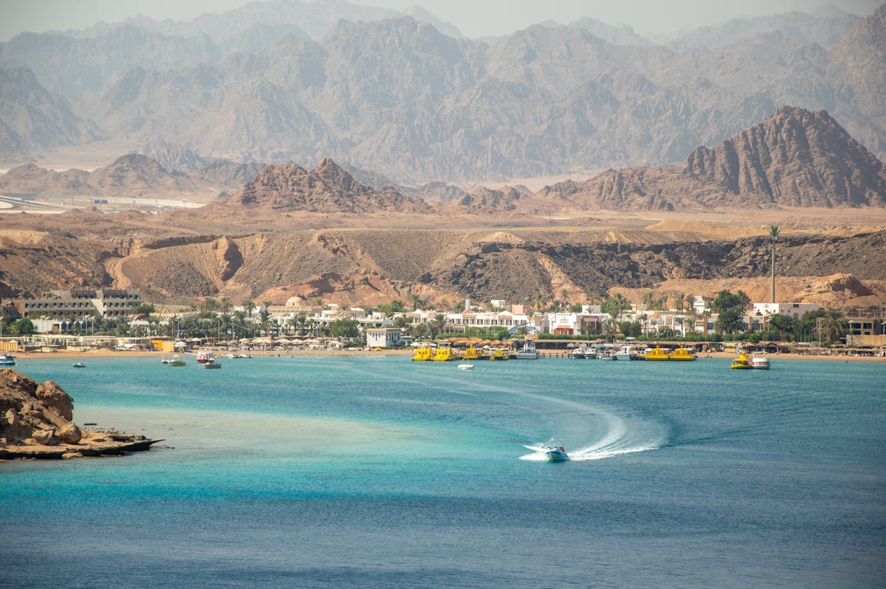 A stunning seaside town with turquoise waters and rugged mountains.