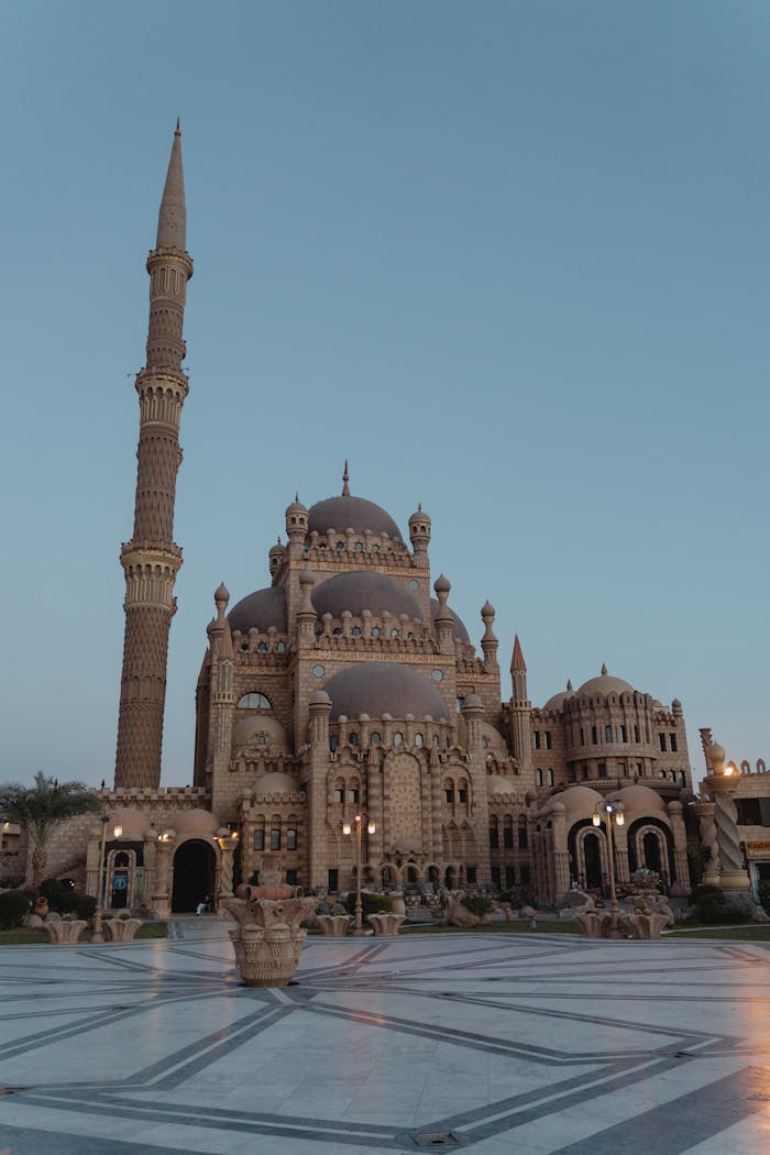 Beautiful view of Al Sahaba Mosques intricate facade and towering minaret against a clear dusk sky in Sharm el-Sheikh, Egypt.